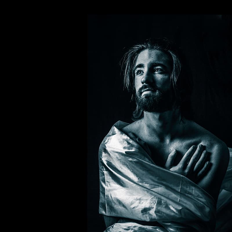 Man standing with silk material wrapped around him