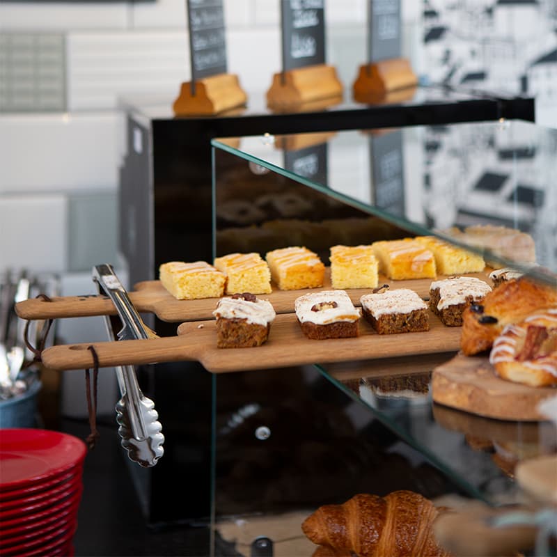 A selection of cakes on wooden boards.