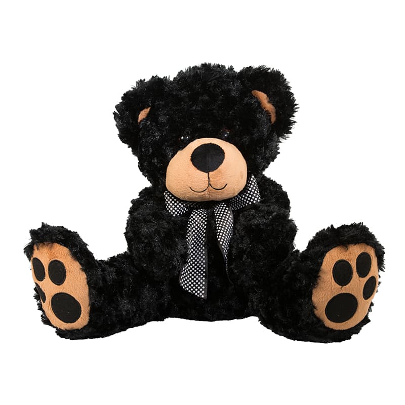 Big cuddly soft toy black bear sitting wearing a black and white bow tie.