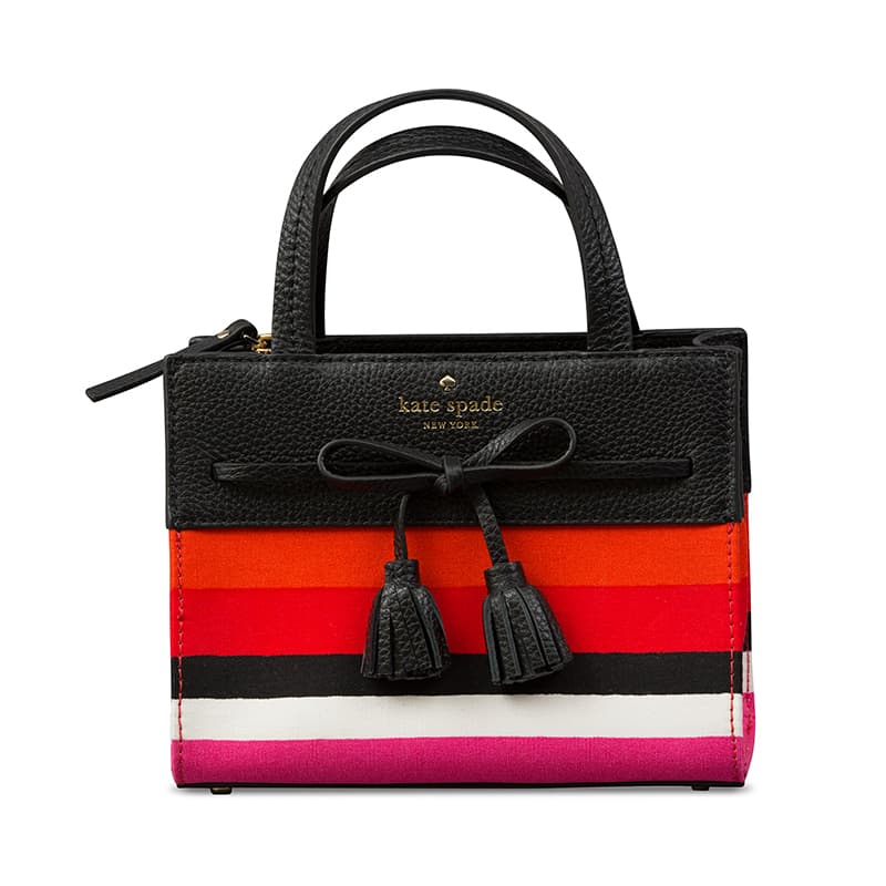 Photograph of a black, white and red Kate Spade leather handbag.