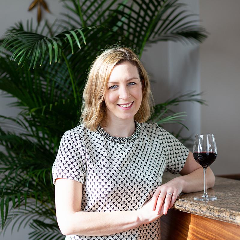 Portrait of a woman leaning by a bar