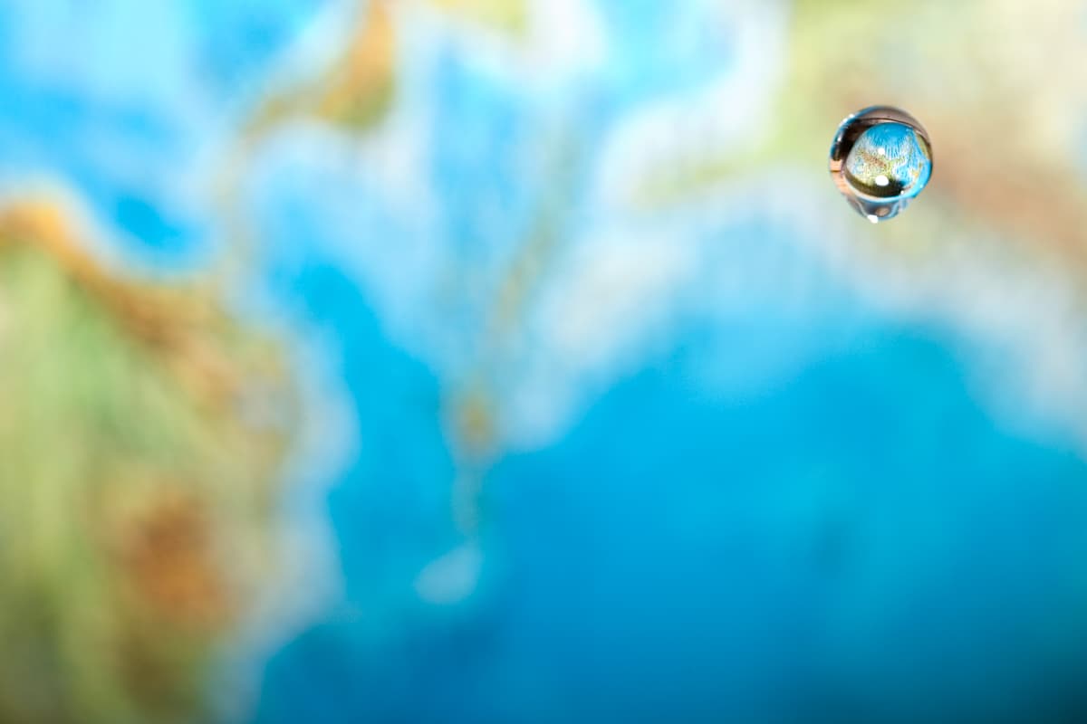 Droplet of water in front of the world.